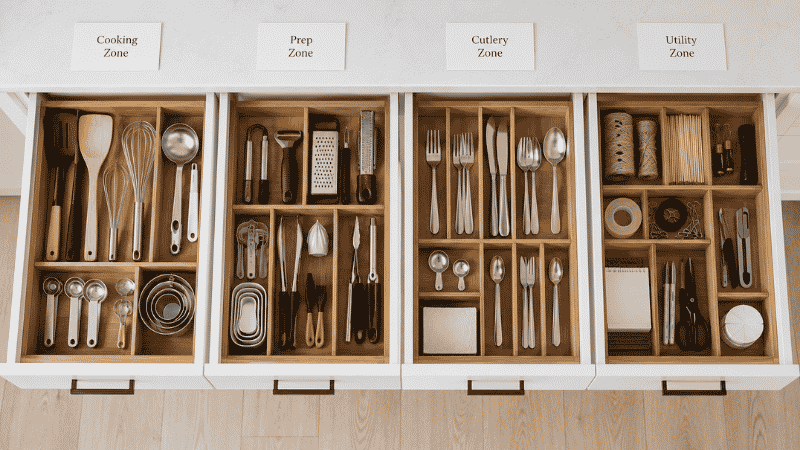Four kitchen drawers each assigned a zone — cooking, prep, cutlery and utility — with bamboo dividers