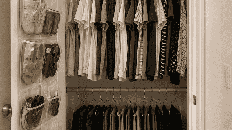 Small closet using vertical space with double hang rod shelf riser and over-door organizer